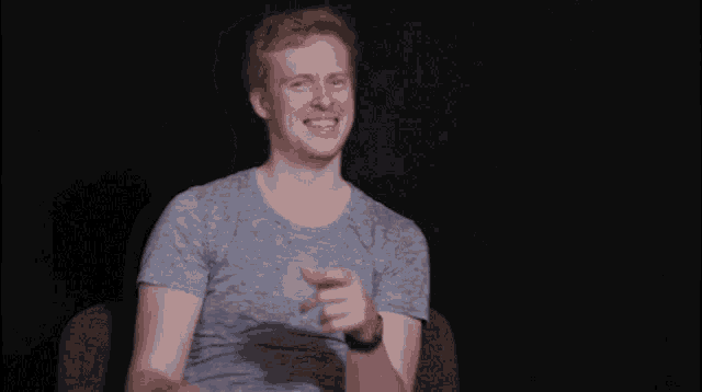 a man with red hair is pointing at the camera