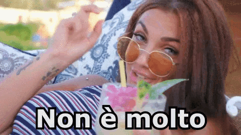 a woman wearing sunglasses is drinking a cocktail with the words non e molto written on the bottom