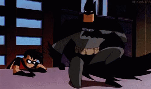 batman and robin from the batman animated series are standing next to each other .