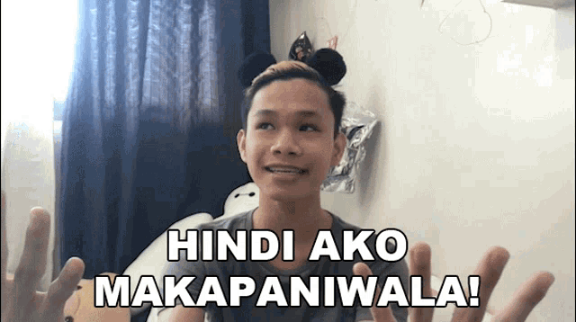 a young man wearing mickey mouse ears says hindi ako makapaniwala !