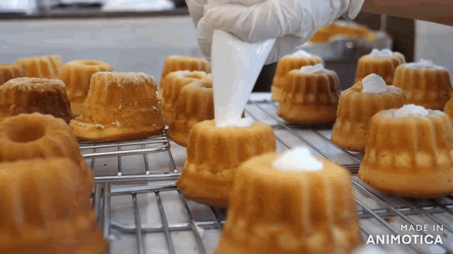 a bunch of cakes are sitting on a cooling rack and the words made in animotica are on the bottom