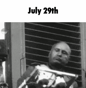 a black and white photo of a man standing in front of a window with the date july 29th .