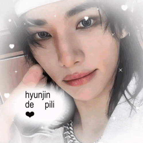 a close up of a person 's face with the words hyunjin de pili written above it