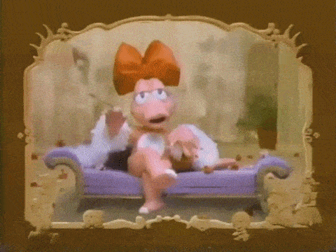 a cartoon character is sitting on a purple couch