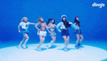 a group of girls are dancing in front of a blue background and the word dingo is on the bottom