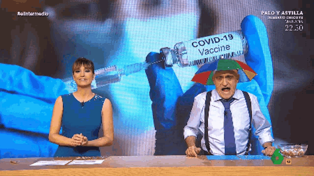 a man wearing an umbrella is holding a covid-19 vaccine