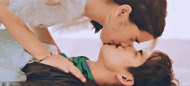 a man and a woman kissing with a watermark that says ncg