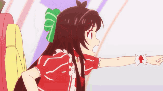a girl in a red dress with a green bow in her hair