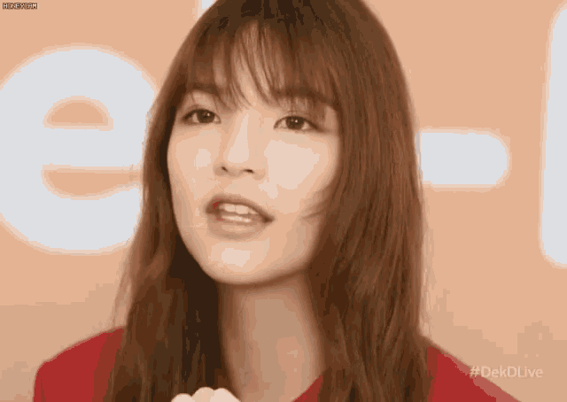 a close up of a woman 's face with the hashtag #dekdlive on the bottom