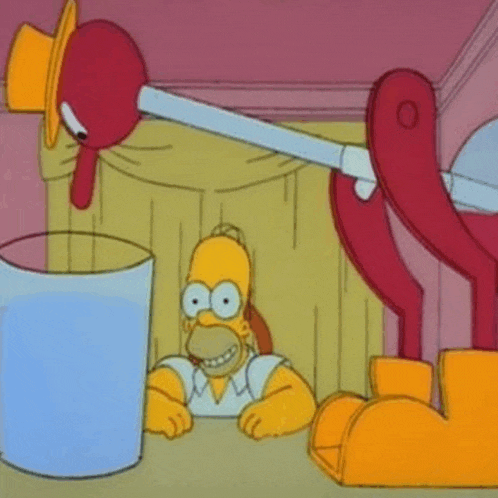 homer simpson is sitting at a table with a glass of water in front of him .