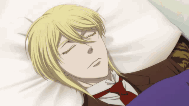 a man in a suit and tie is sleeping in a bed with his eyes closed