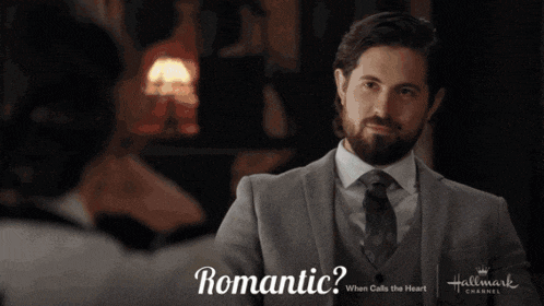 a woman wearing glasses is sitting at a table with the words " romantic " behind her