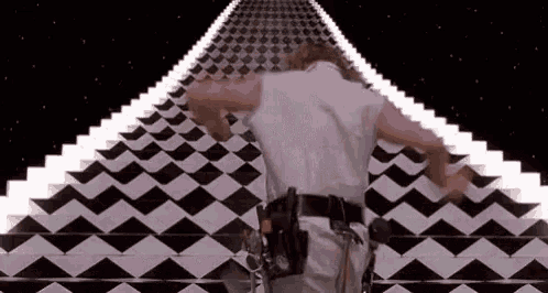a man is standing on a black and white checkered floor in a video game .