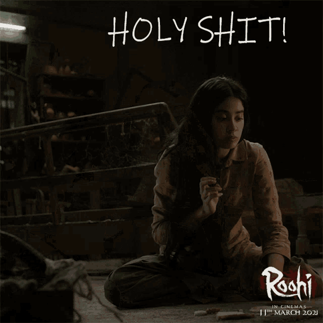 a poster for a movie called rochi shows a girl sitting on the floor