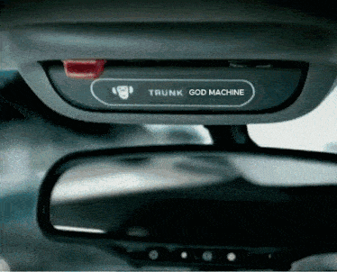 a rear view mirror with a trunk god machine sticker on it