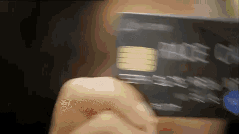 a blurry picture of a person holding a credit card with the word blue on it