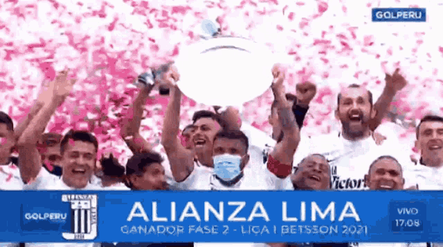 a group of alianza lima soccer players holding a trophy