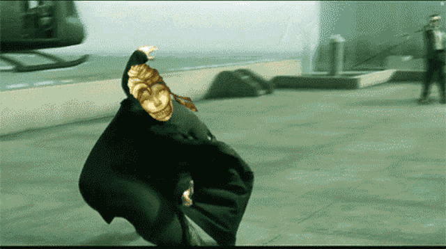 a man in a black suit is being thrown by a statue