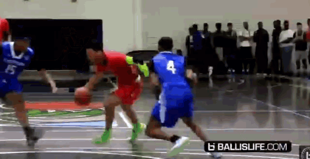a group of basketball players are playing a game on a court sponsored by ballislife.com