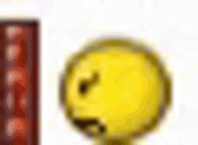 a close up of a yellow smiley face on a white background
