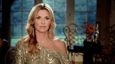 a woman in a gold sequined off the shoulder top