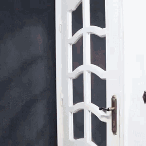 a close up of a white door with a black background
