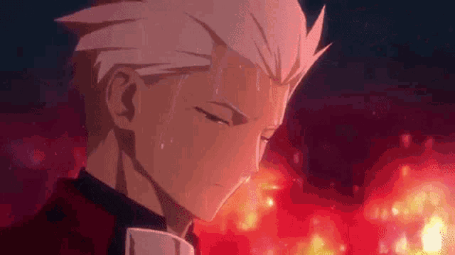 a man in a tuxedo is standing in front of a fire and crying .