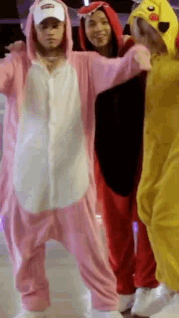 a group of people are standing next to each other wearing costume .