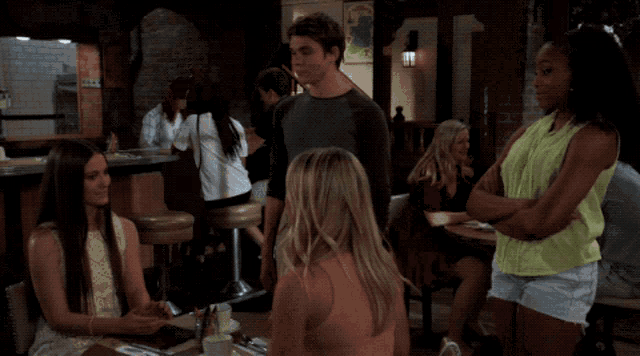 a woman in a green shirt is looking at something