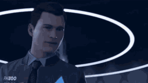 a man in a suit is holding a gun in his hand and pointing it at the camera .