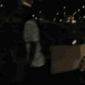 a man is getting out of a car at night .