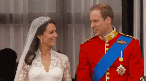 a bride and groom are standing next to each other and smiling .