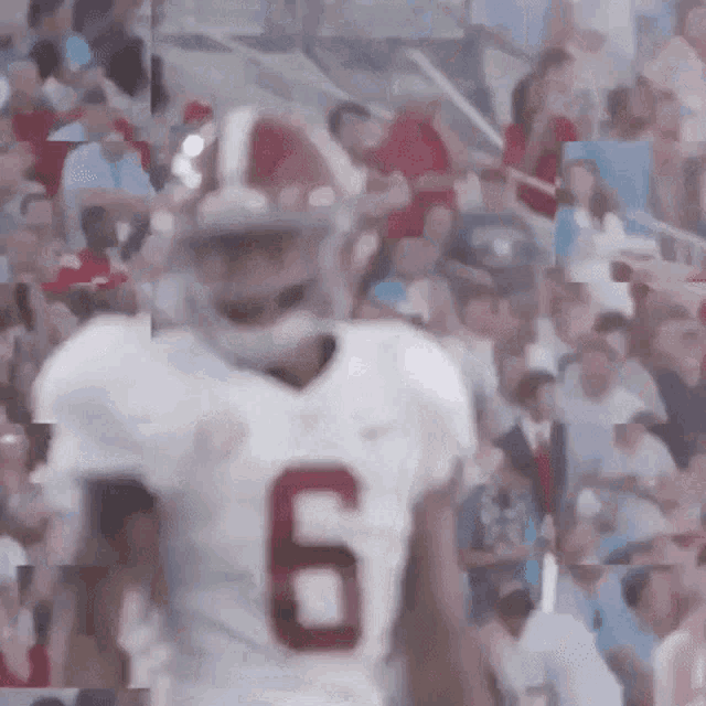 a football player in a white jersey with the number 6 on it