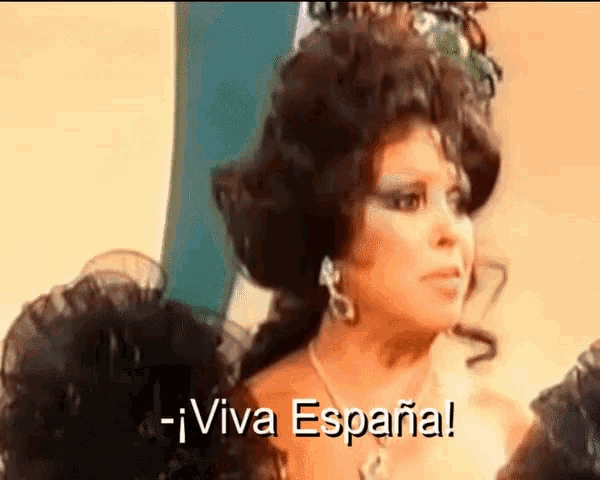 a woman wearing a wig and earrings says viva espana