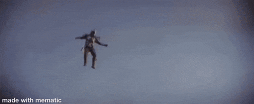 a person is jumping in the air with their arms outstretched and a sunset in the background .