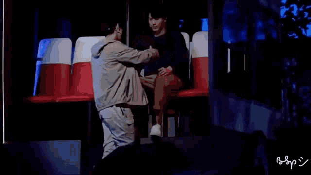 a man and a woman are hugging each other while sitting in a chair .