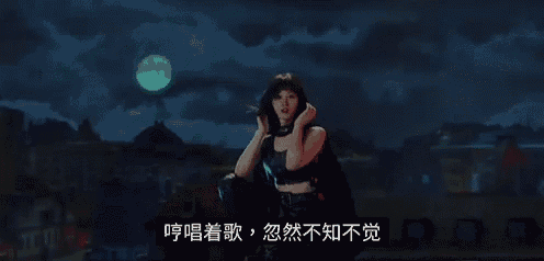 a woman is standing in front of a full moon in a dark city .