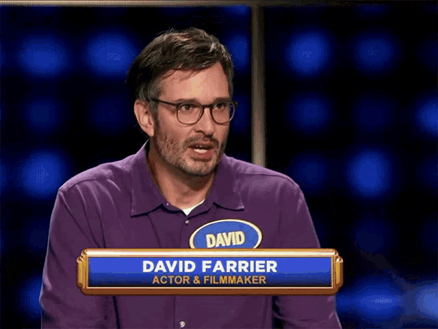 a man in a purple shirt with the name david on it