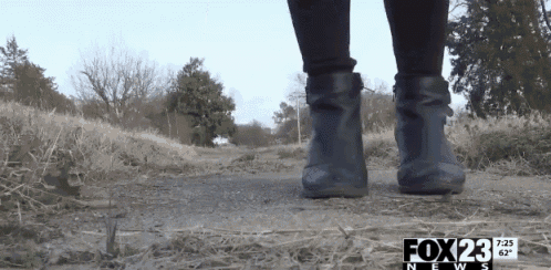 a person is walking on a dirt path with the fox 23 news written on the bottom