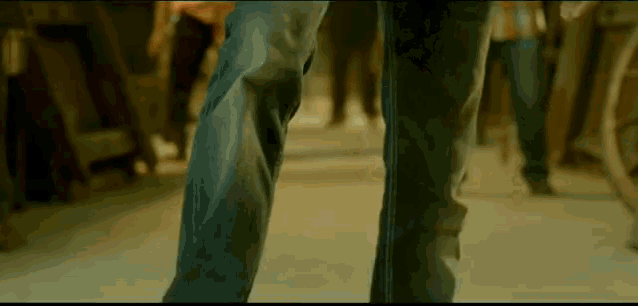 a close up of a person 's feet in blue jeans
