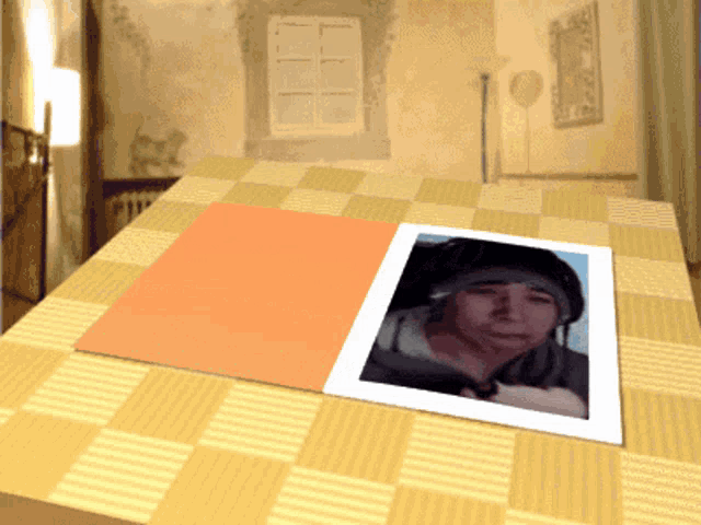 a picture of a person is on a table with a checkered table cloth