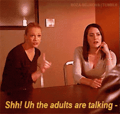 two women sitting at a table with the words shh uh the adults are talking on the bottom