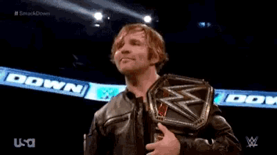 a wrestler is giving a thumbs up while wearing a wrestling belt .