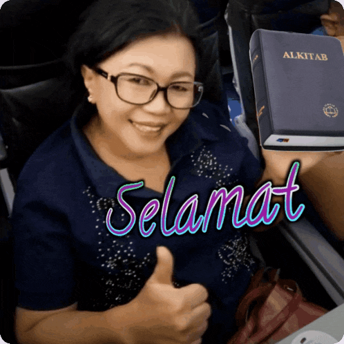 a woman giving a thumbs up next to a bible that says selamat