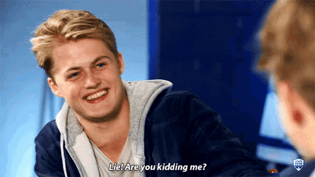 a young man is smiling and talking to another man and the words lie are you kidding me