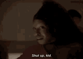 a close up of a person 's face with the words `` shut up , kid . ''