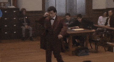 a man in a suit and bow tie stands in front of a group of people with the words " everything that guy just said " below him
