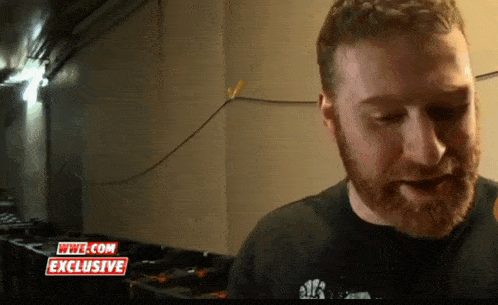 a man with a beard is on a wwe.com exclusive interview