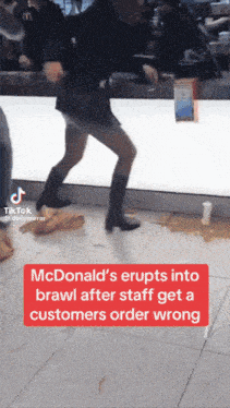 a woman dancing in a mcdonald 's with a caption that says mcdonald 's erupts into brawl