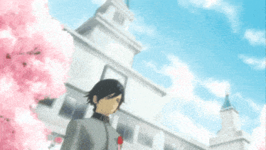 a boy stands in front of a white building with pink flowers in the background